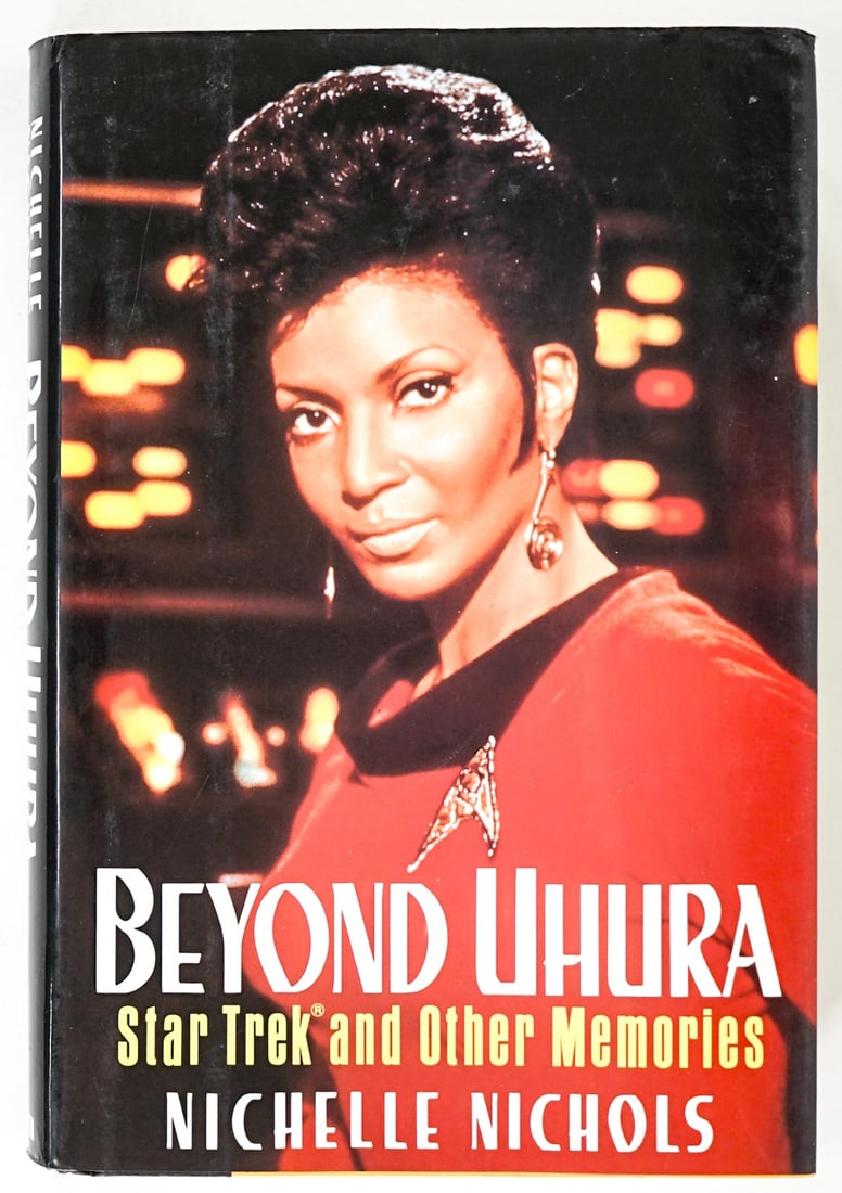 Beyond Uhura by Nichelle Nichols SIGNED: Beyond Uhura by Nichelle Nichols. Signed on title page. Beckett Authentication Services #BR88807. G. P. Putnam's. 1994 with unclipped dust jacket. 320 pp. Photo Illustrations. Two-tone covers, bumps t