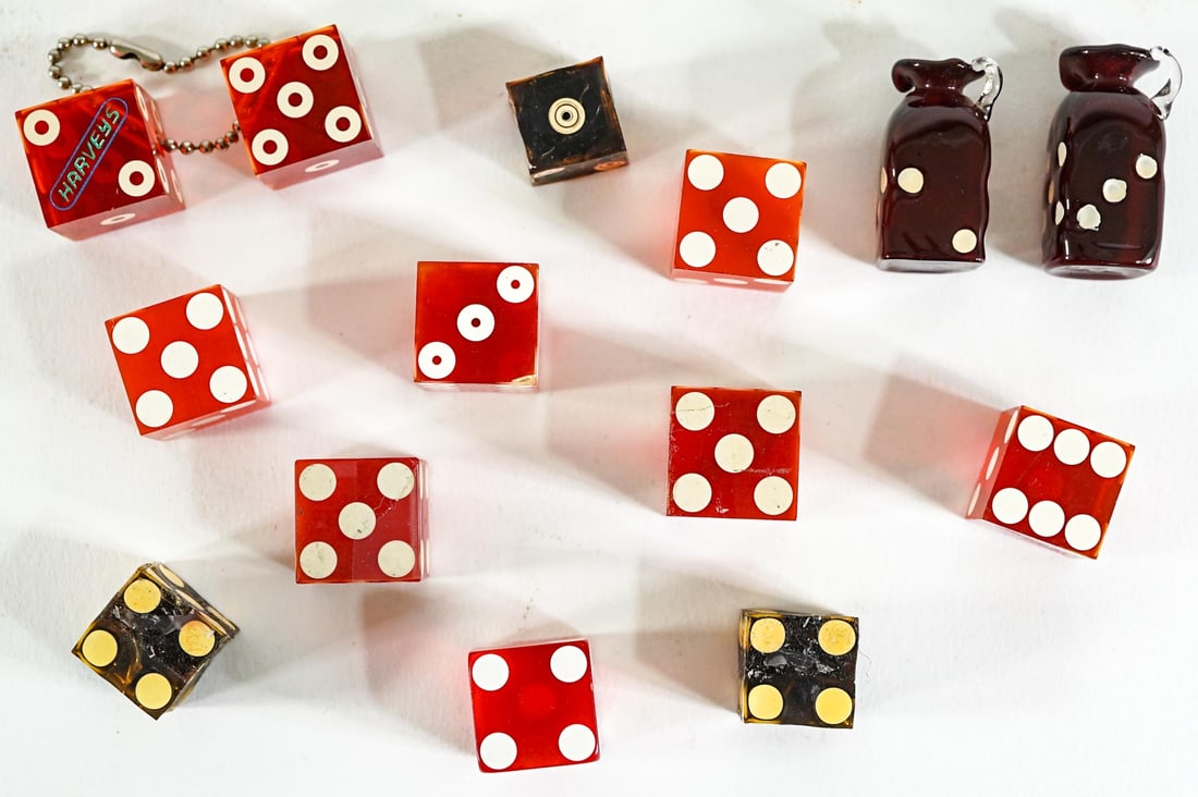 Vintage Casino Dice, Dice Collectibles: [Harrah's, Harvey's] Vintage Casino Dice, Dice Collectibles. Dice in this lot measure .625-.75. The group measures 3.5 x 3.5 x 1 inches. The descriptions of items appearing in advertising prior to thi