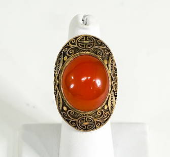 Chinese Gold Carnelian Ring: Chinese Gold Carnelian Ring. Gold tests 10k gold in most spots, stronger in some parts and lesser in some spots. Crown (head) of ring measures 38 x 26 mm. Oval Carnelian measures approximately 3 ctw,