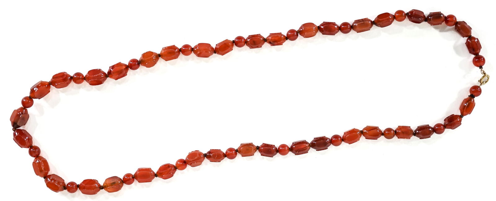 Glass Bead Necklace: Glass or Carnelian Bead Necklace. Largest bead measures 16 x 11 mm, smallest bead measures 9 mm diameter. Total length 30 inches. For shipping purposes measures 8 x 3 x 2 inches. The absence of a cond