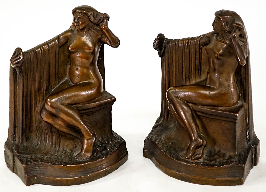 KBW Kathodian Bronze Pair Bookends [Woman]: KBW 'Art Bronz' clad pair bookends. Nude woman seated. Each bookend measures 7.25 x 5.125 x 3.5 inches. No damage. The absence of a condition report does not imply that the lot is in perfect condition