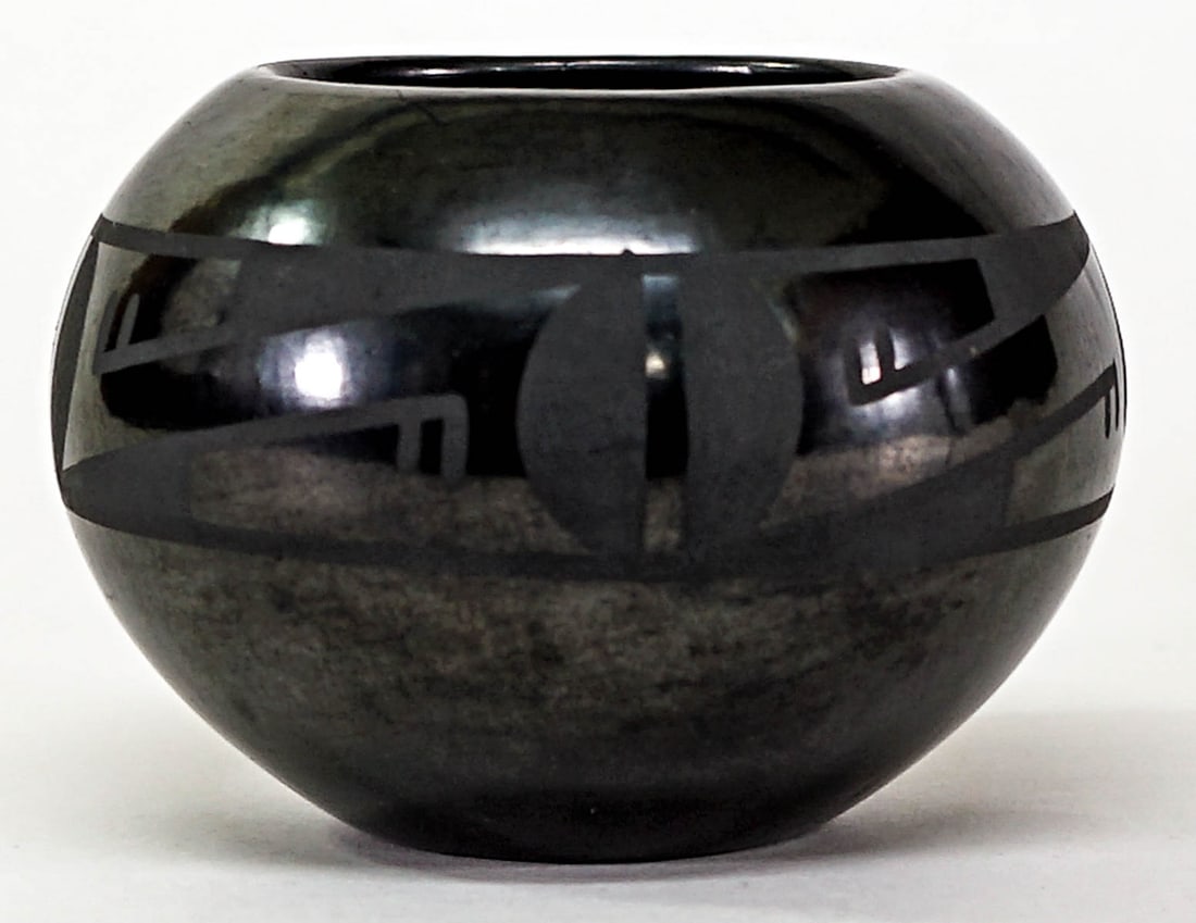 Maria Martinez and Popovi Da San Ildefonso Pot: Maria Martinez (San Ildefonso, Pueblo 1887-1980) blackware pot decorated by her son Popovi Da (1923-1971). Measures 3 in. high x 4.25 in. diameter. The rim measures 2.375 in. across. SIGNED underside.