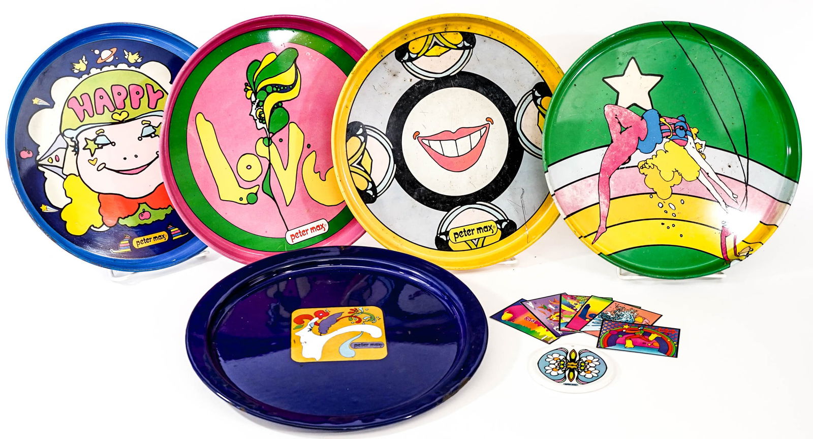 Peter Max Metal Trays, Coaster, Trading Cards: The trays measure 12.75-13.375 inches diameter and are in mixed condition. The absence of a condition report does not imply that the lot is in perfect condition or completely free from wear and tear,