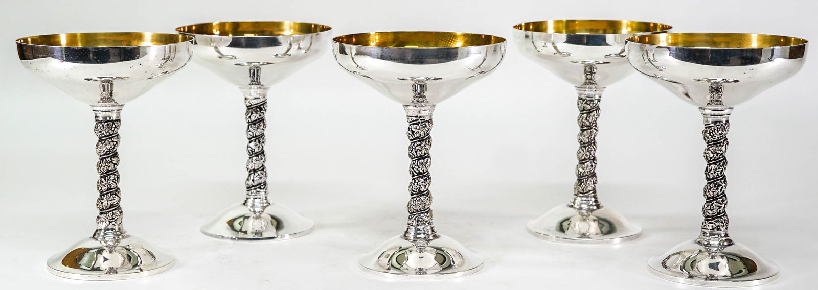 Vintage Nieman Marcus (5) Silverplate Goblets: Five (5) Silverplate Plator Spain champagne goblets. Each measures 5.625 in. tall x 4.25 in. diameter. Lot measures 5.625 tall x 12 x 12 in. for shipping purposes. The absence of a condition report do