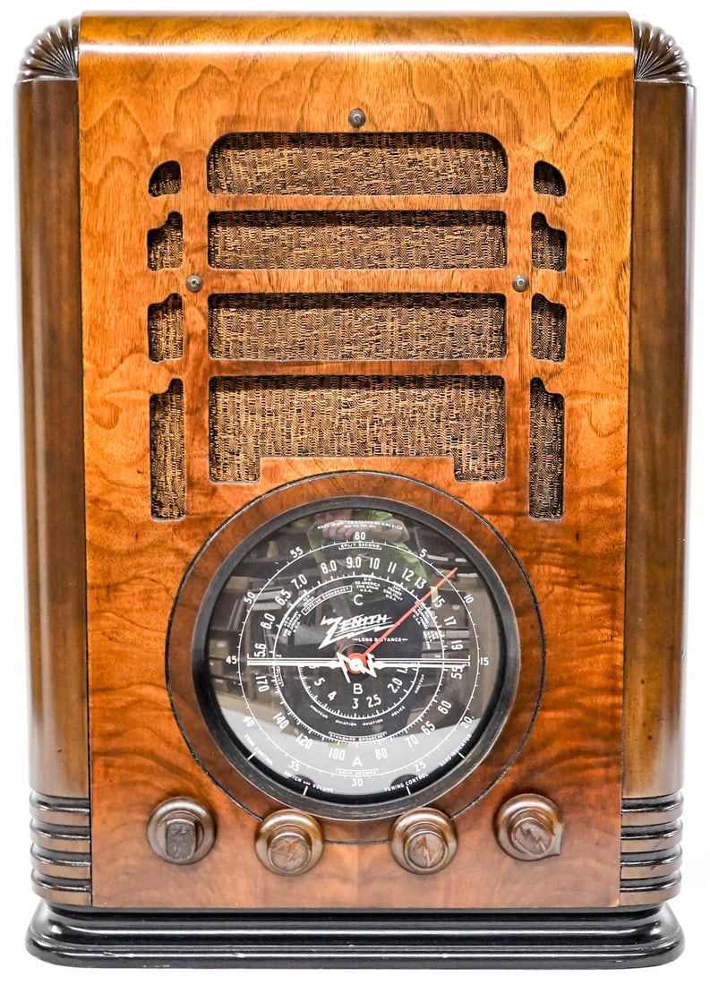 Zenith 1935 Wood Tombstone Radio: Professionally refinished and likely serviced. Powers up, does not grab a signal. Measures 19 x 10 x 13.5 inches. The absence of a condition report does not imply that the lot is in perfect condition
