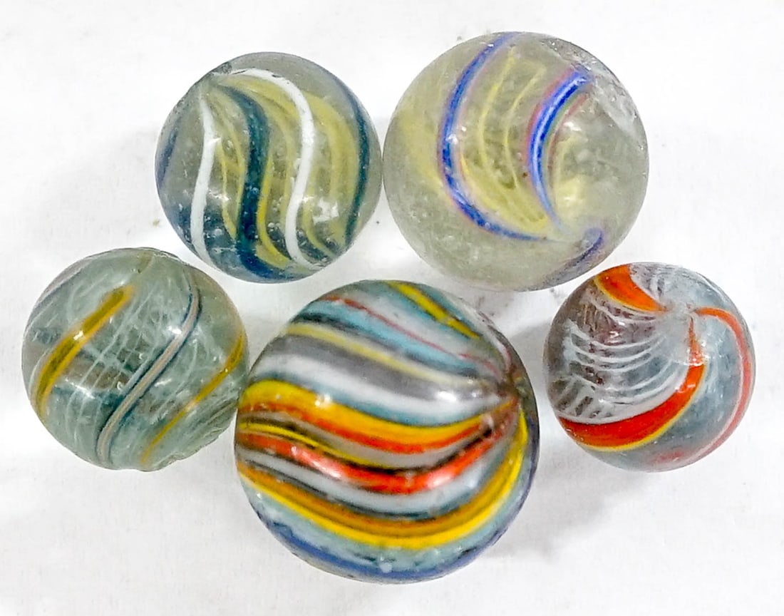 (5) Antique Swirl Glass Marbles: (5) Antique Swirl Glass Marbles. They measure .625-.875 inches diameter. Mixed condition. The descriptions of items appearing in advertising prior to this auction are believed to be correct, neverthel