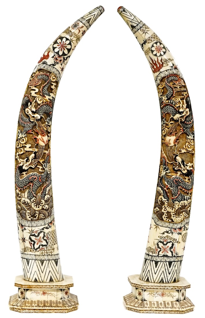 Chinese Tusk-Form Bone Sculptures: Chinese Tusk-Form Bone Sculptures Mounted on Wooden Stands. These items are designed to resemble tusks and are created from pieced bone over wood core. Each measures approximately 31 inches tall x 7 x