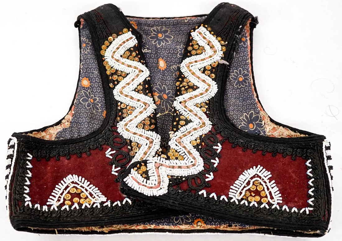 Beaded Child's Vest: Measures 12.5 in. across back at underarms and 12 in. across back at lower edge. Measures 10.25 in. from back collar to lower edge. Lot measures 12 x 13 x 1.5 in. for shipping purposes. The absence of