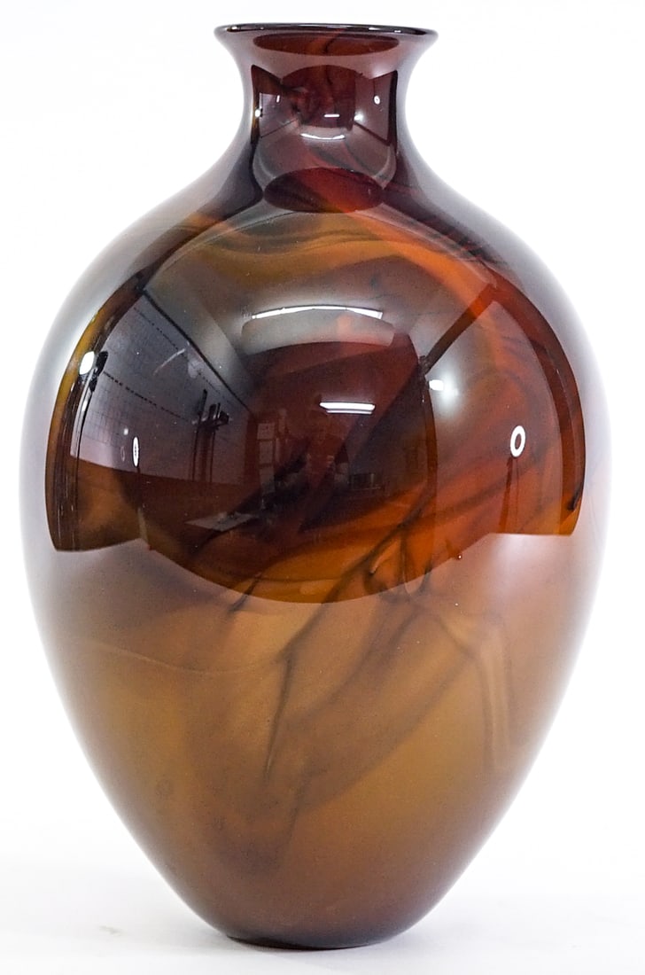 Studio Art Glass 12IN Vase Illegibly Signed: Illegibly signed studio art glass, earth tones. Measures 12 in. tall x 7 in. x 7 in and 3 in. across rim. No evident cracks, chips or repairs. Measures 12 x 7 x 7 in. for shipping purposes only. The a