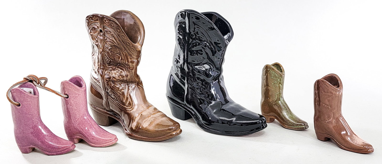 Frankoma Pottery (6) Cowboy Boots: Includes: Two (2) #133; two (2) #31; #27 and #28. Measure 3.75 in. to 7 in. tall. No evident cracks, chips or repairs. Measures 3 x 15 x 8 n. for shipping purposes only. The absence of a condition rep