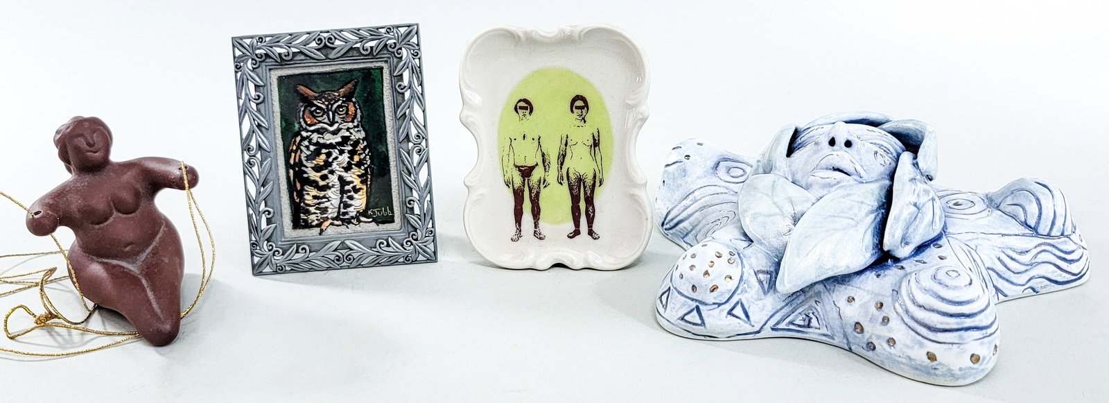 Ceramics and Print [K. Jubb; Janet Whaley]: Unusual art pieces. 1) Gouache (owl) signed K. Jubb measures 3.125 in. 2.125 in. Frame measures 4.5 x 3.5 in. 2) Ceramic face signed Janet Whaley measures 7 in. x 7 in. ...and more. Measures 3 x 12 x