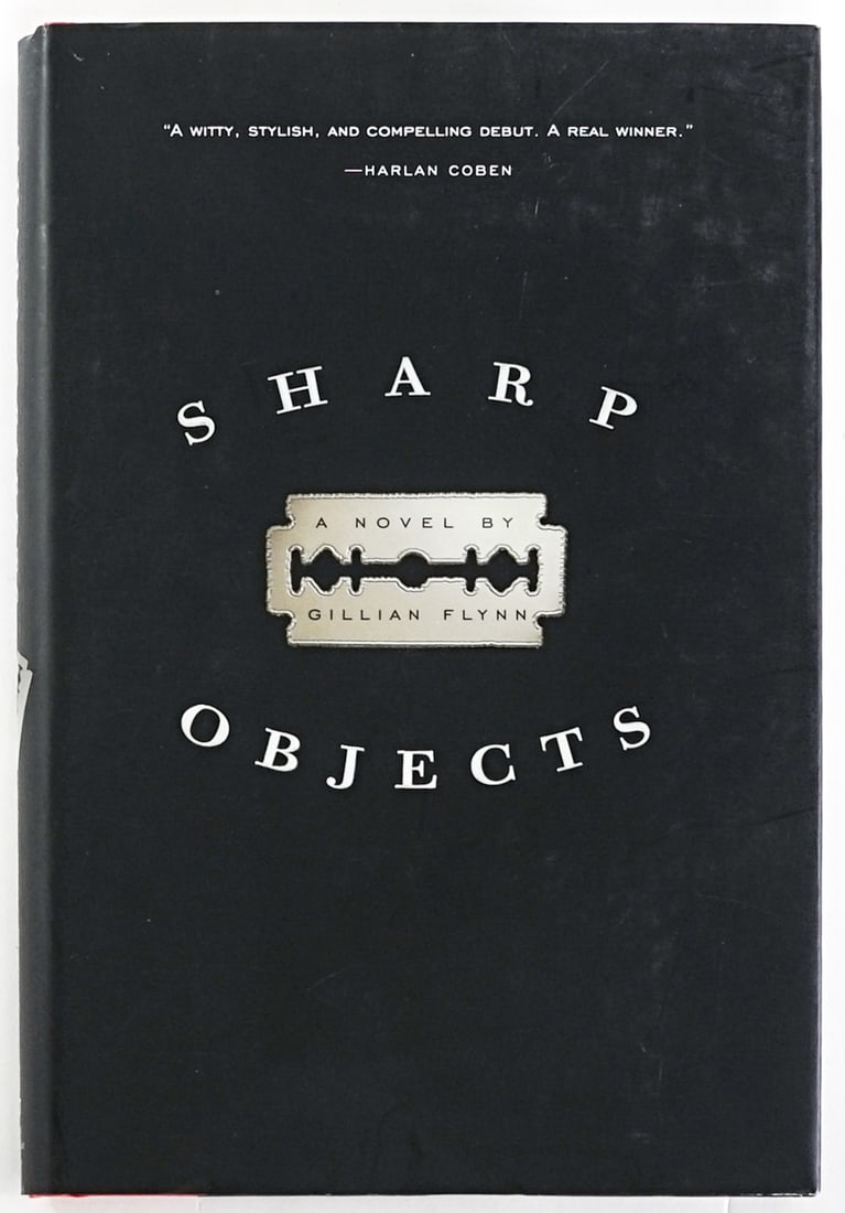 Sharp Objects by Gillian Flynn SIGNED 2006 1ST: Sharp Objects by Gillian Flynn signed on title page. Shaye Areheart Books 2006 1st edition with unclipped dust jacket, 252 pp. Two-tone black and red covers. Book lot measures 9.5 in. H x 6.5 in. W x