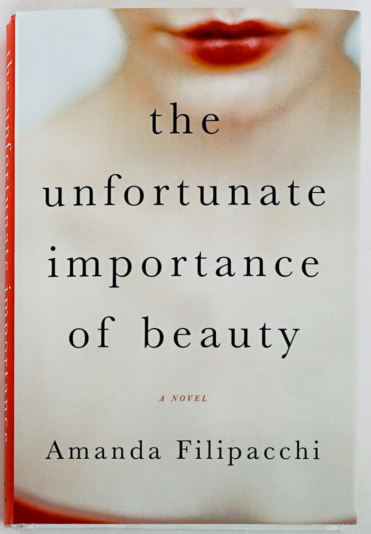 Unfortunate Importance Beauty - Filipacchi SIGNED: The Unfortunate Importance of Beauty by Amanda Filipacchi signed on title page. W. W. Norton 2015 first edition with unclipped dust jacket. 332 pp. White covers. Book lot measures 8.5 in. H x 5.75 in.