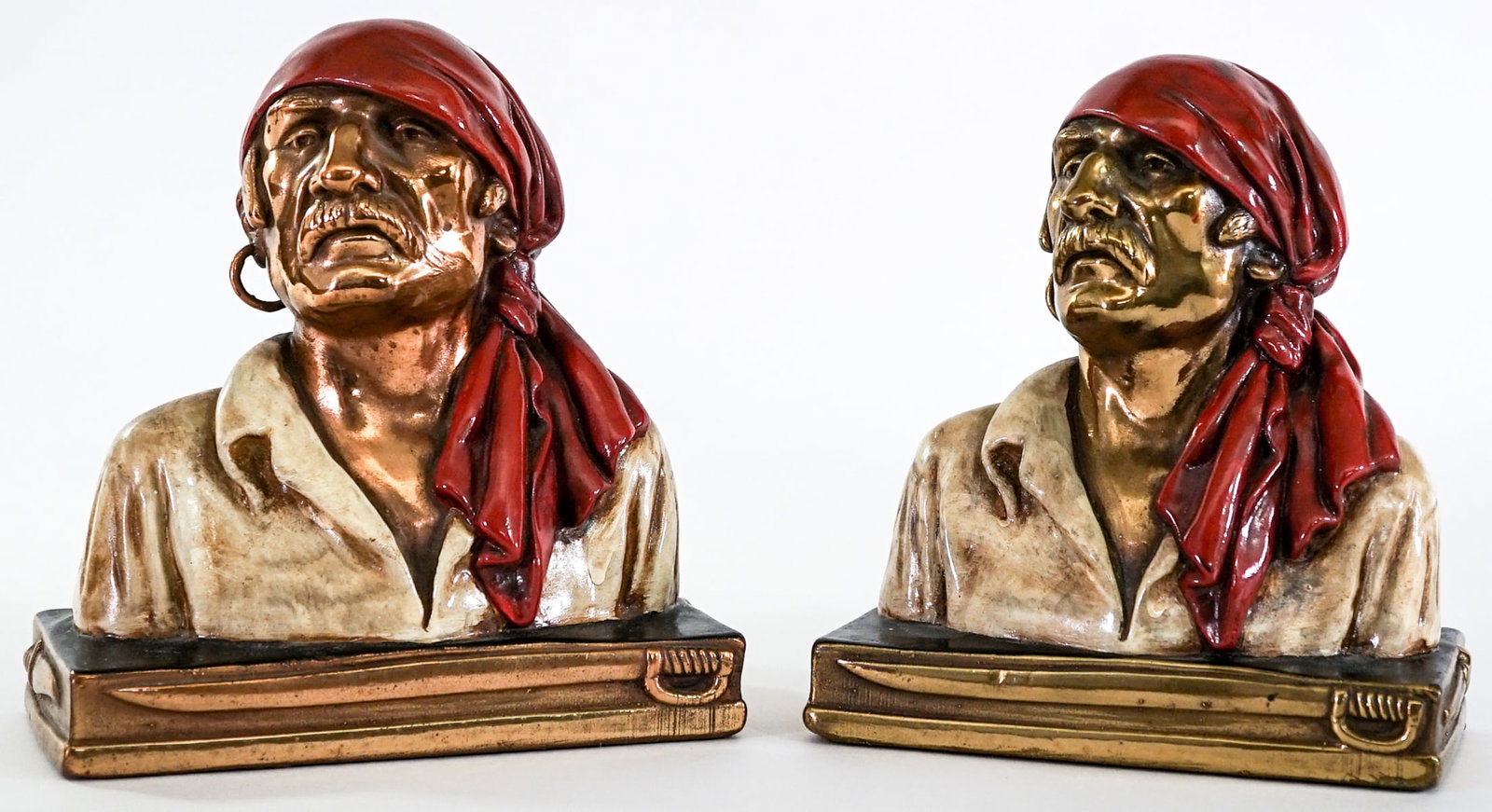 Bronze Clad Pirate / Buccaneer (Pair) Bookends: Pair of bronze clad pirate bust vintage bookends. EACH measures 7 x 6.25 x 3.375 in. Lot measures 7 x 6.25 x 7 inches for shipping purposes. The absence of a condition report does not imply that the l