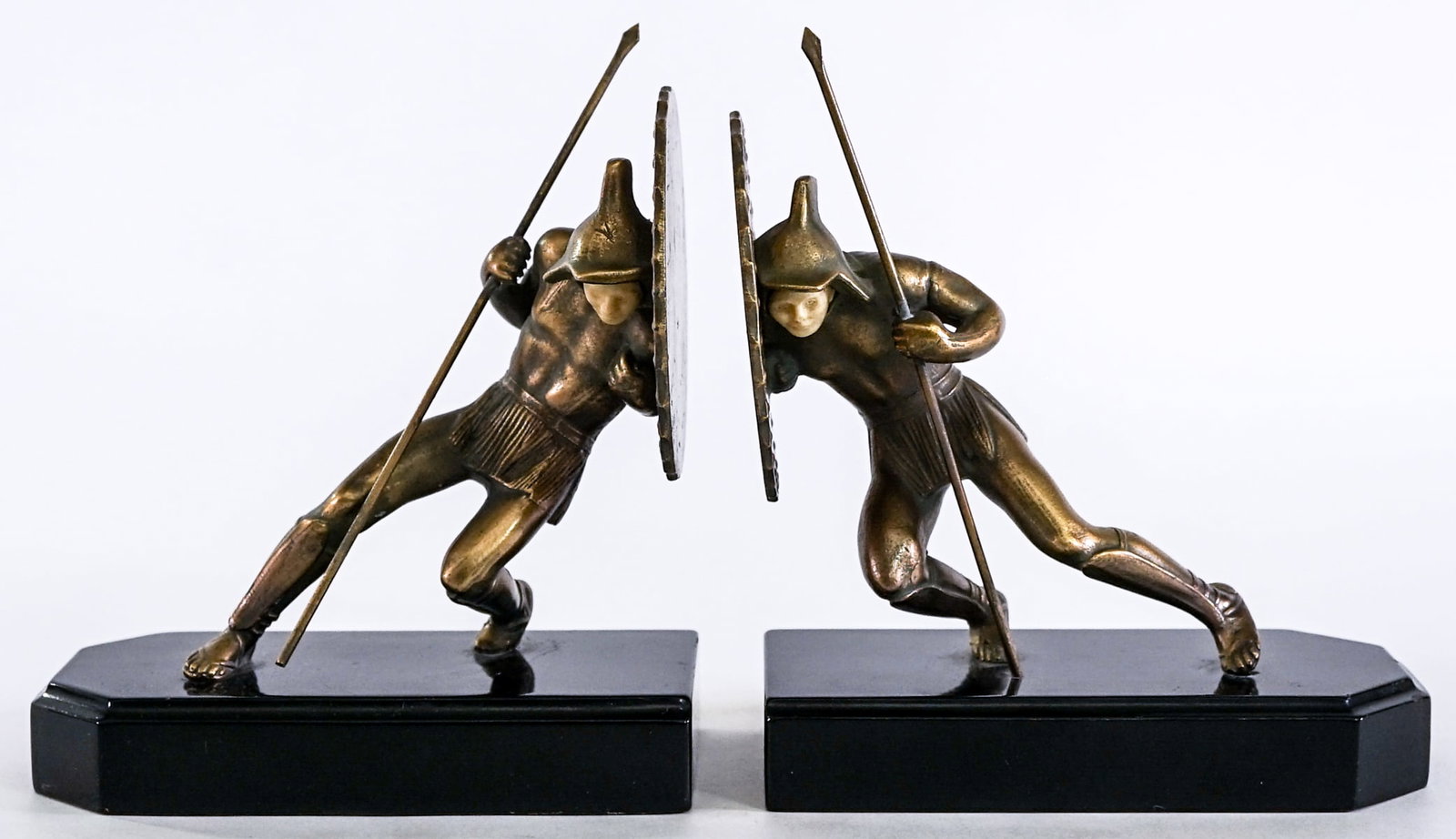 Art Deco (Pair) Metalware Bookends [Warrior]: Art Deco (pair) Warrior with Spear and celluloid face. Gold gilted metalware with base. EACH measures 7 x 6.25 x 3 in. Lot measures 7 x 6.25 x 6 inches for shipping purposes. The absence of a conditio