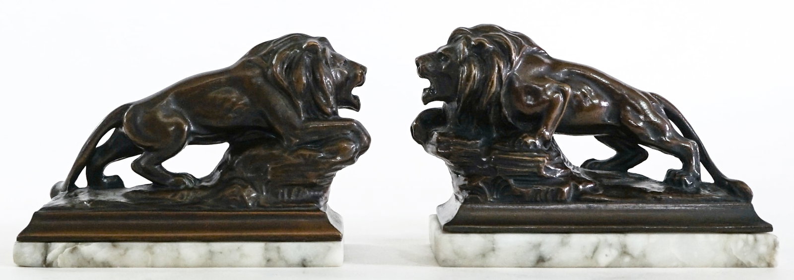 Vintage Small Bronze Lion Bookends / Paperweights: Bronze lion bookend on marble base (note surface chip to lower edge on one). EACH measures 3.25 x 4.75 x 2.25 in. Lot measures 3.25 x 4.75 x 4.5 inches for shipping purposes. The absence of a conditio