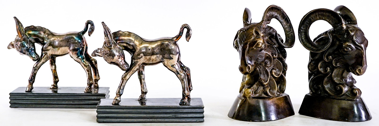 Vintage Ram and Deer (2 Pair) Bookends: 1) Ram cast metal bronze-tone pair. EACH measures 6.25 x 3.75 x 3.5 in. 2) Deer cast metal silver-tone. Each measures 5.25 x 6 x 2.25 in. Lot measures 6.25 x 7.5 x 8.5 inches for shipping purposes. Th