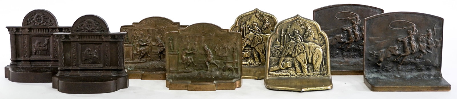 Antique (4 Pair) Bookends: Four (4) Pair antique bookends. 1) Western scene cast metal measures 5 x 5.25 x 2.5 in. each. 2) Man at desk cast iron measures 5 x 5 x 2.5 in. each. 3) Ancient scene brass measures 4.25 x 5.125 x 1.5