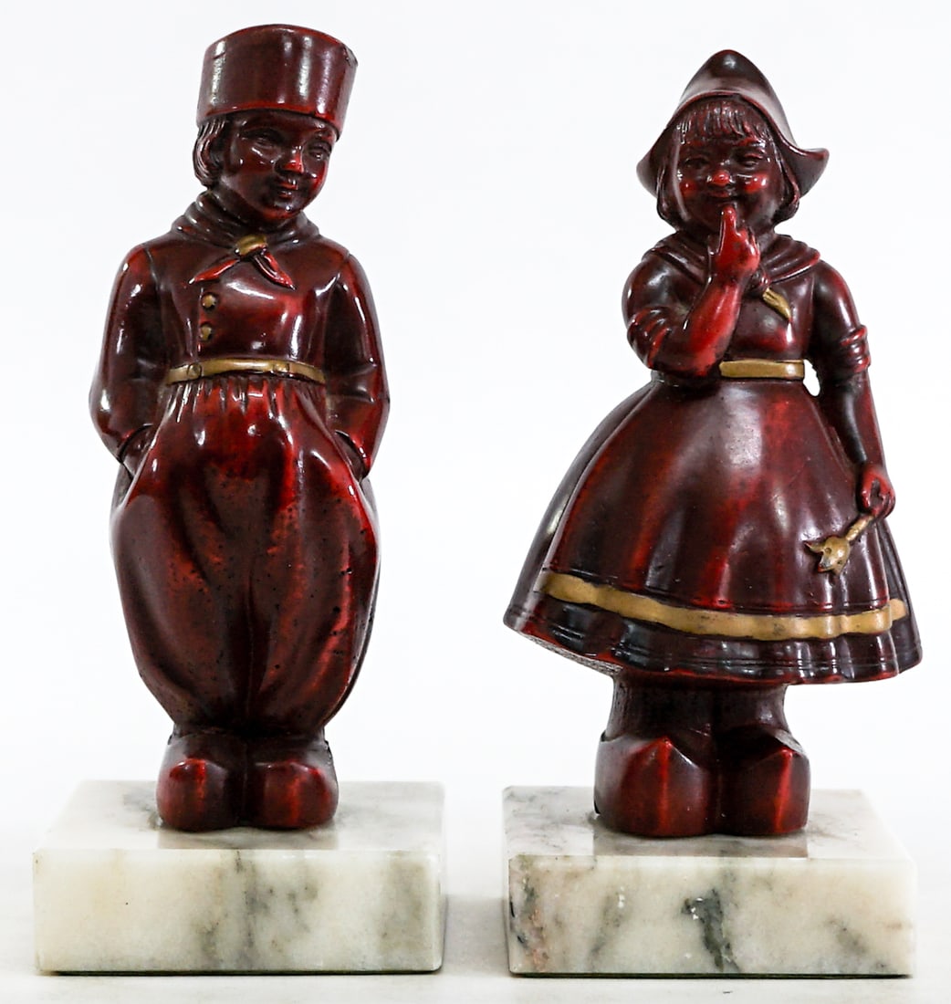 Dutch Girl & Boy / Marble Base (Pair) Bookends: Red ceramic Dutch boy and girl on marble bases (pair) bookends. EACH measures approximately 7 in. tall with stand x 3.25 x 3 in. Lot measures 7 x 3.25 x 6 inches for shipping purposes. The absence of