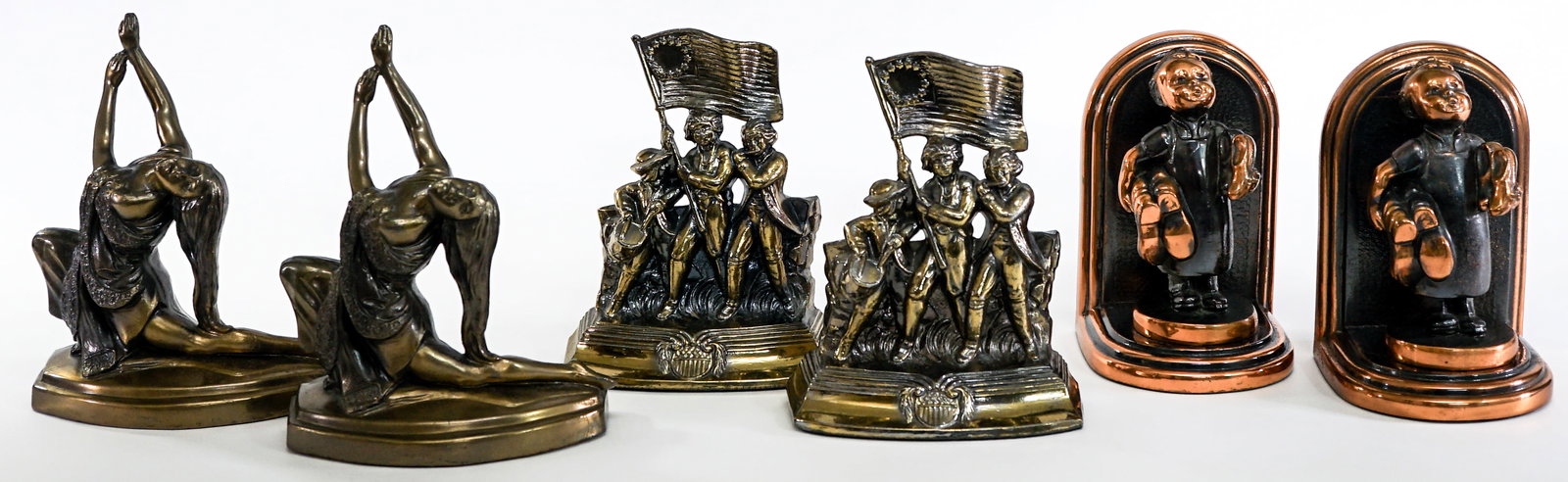 Vintage (3 Pair) Cast Metal Clad Bookends: Includes: 1974 SCC Brass/Metal American Revolution 13 Colonies Soldier Flag Drum; Girl Dancing; Boy with Shoes. Measure 6.5 to 7.5 in. tall. Lot measures 7.5 x 12 x 11 inches for shipping purposes. Th