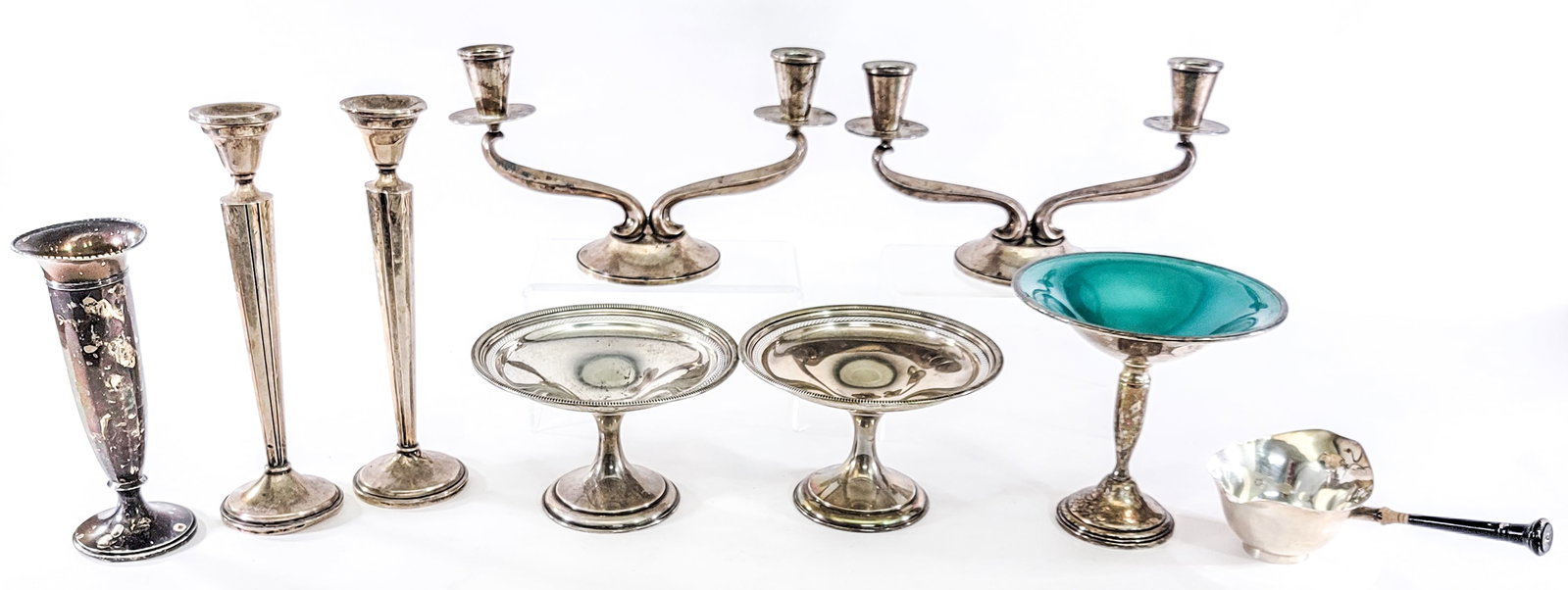 Weighted Sterling (9) Assorted Items: Nine (9) assorted weighted sterling pieces. Lot measures 10.5 in. H x 17 in. W x 13 in. D for shipping purposes only. The absence of a condition report does not imply that the lot is in perfect