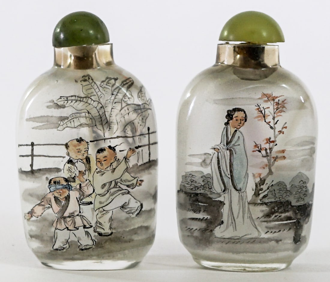 Pair Inside Painted Snuff Bottles [Figural]: Pair of inside painted snuff bottles. Note one stopper was glue repaired and needs repair. AS-IS. Each measures 3 in. tall x 1.75 in. wide x 1 in. deep. Lot measures 3.5 in. H x 3.5 in. W x 1.5 in. D