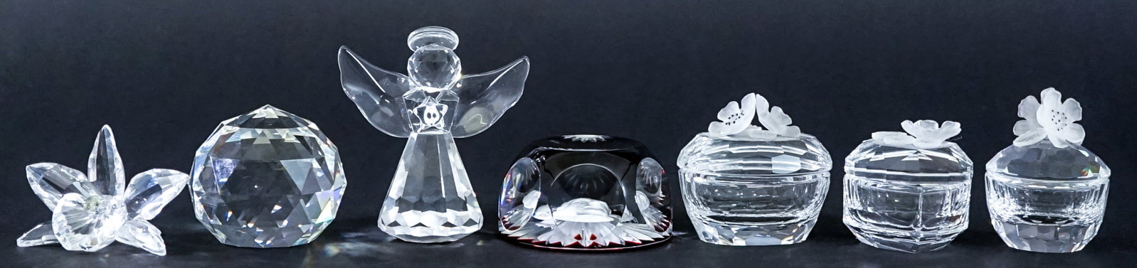 (7) Crystal Sculptures / Lidded Trinket Boxes: Seven (7) small crystal sculptures and lidded trinket boxes. Measure 1.75 to 3 in. tall. No evident cracks, chips or repairs. Lot measures 3 in. H x 9 in. W x 9 in. D for shipping purposes only. The a