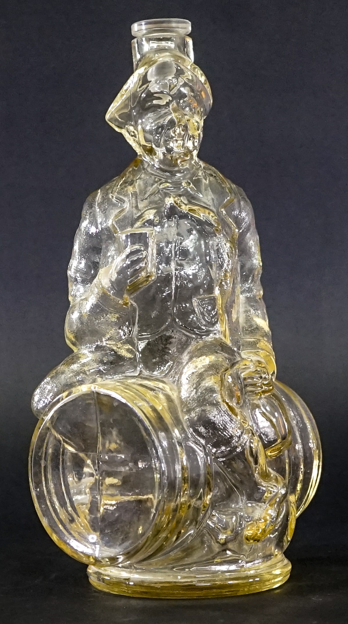 Vintage Clear Glass Decanter [Man on Barrel]: Vintage Clear Glass Italian decanter with stopper. Measures 11 x 5.5 x 4.75 in. Lot measures 11 in. H x 5.5 in. W x 4.75 in. D for shipping purposes only. The absence of a condition report does not im