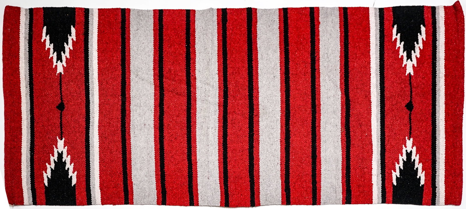 Handwoven Rug: Measures 27.5 x 58 inches. Excellent condition. The absence of a condition report does not imply that the lot is in perfect condition or completely free from wear and tear, imperfections, or the condi