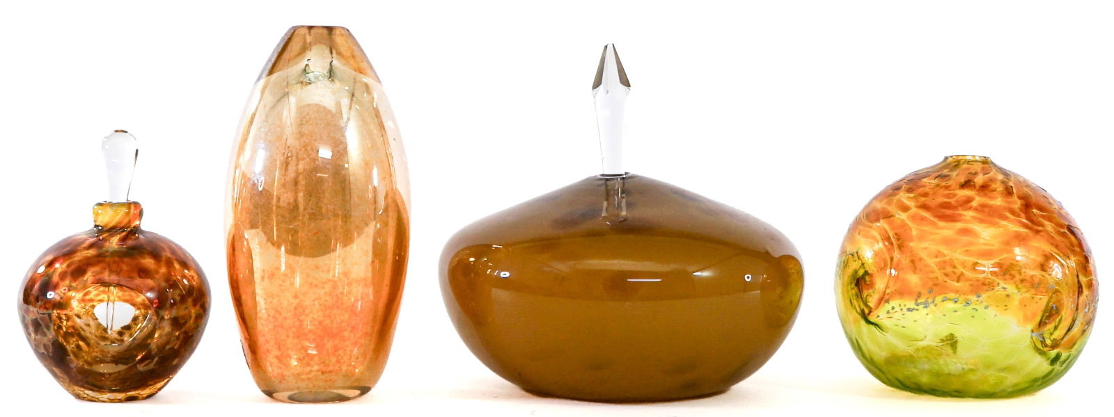Art Glass (4) Oil Lamps /Bottles [Amber]: Four (4) art glass oil lamps / bottles. Artists include Brian Maytum and Audrey Handler SIGNED. Measure up to 6.5 in. tall x 5.5 wide. No evident cracks, chips or repairs. Lot measures 6.5 in. H x 10