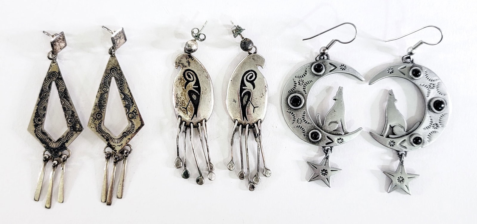 Southwest-Style (3PR) Earrings 14g: Three (3) pair earrings measure 2 to 2.5 in. long. Note the wolf, moon and stars is pewter and not weighed. Lot measures 3.5 in. H x 3.5 in. W x 1.5 in. D for shipping purposes only. The absence of a 