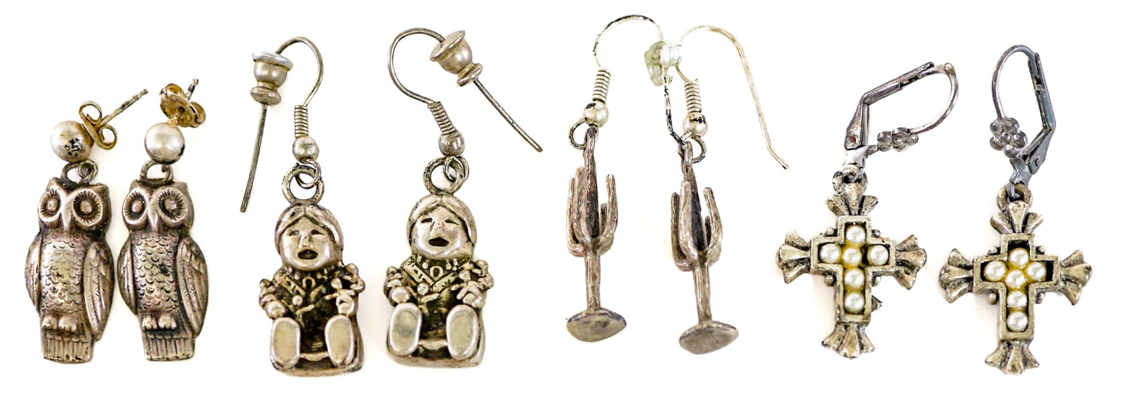 Southwest-Style (4PR) Earrings 22g: Four (4) pair pierced earrings. Measure 1 in. long. Owl, cross, cactus. Lot measures 3.5 in. H x 3.5 in. W x 1.5 in. D for shipping purposes only. The absence of a condition report does not imply that