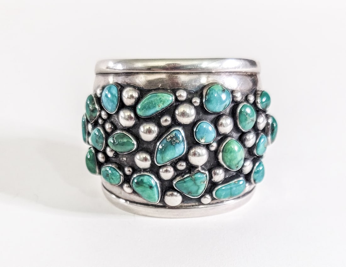 Silver and Turquoise Cuff Bracelet [E. Luben]: Silver and turquoise cuff bracelet signed E. Luben with shooting star mark on verso. Outside measures 6.5 in. wide x 2.25 in. high. Inside circumference measures 5.9375 in. total 7 in. Weighs 82 grams
