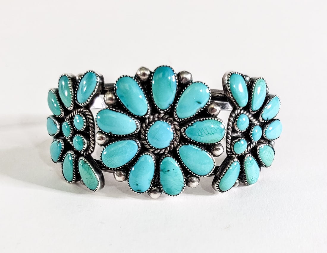 Julie Ordelacy Lahi Silver/Turquoise Bracelet: Julie Ordelacy Lahi (Zuni) silver with inset turquoise cluster bracelet. Outside measures 6.9375 x 1.5 in. Inside circumference measures 5.125 in. total 6.125 in. Weighs 38 grams. Lot measures 4 in. H
