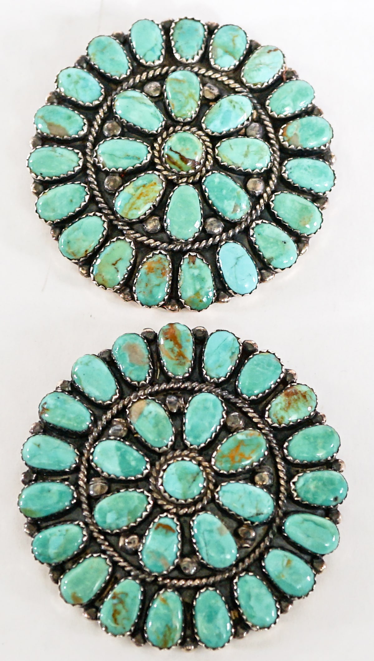 Vintage Pair of Southwest Turquoise Cluster Pins: Vintage pair of Southwest turquoise cluster pins. Unsigned. Each measures 2 in. diameter. Lot measures 3.5 in. H x 3.5 in. W x 1.5 in. D for shipping purposes only. The absence of a condition report d