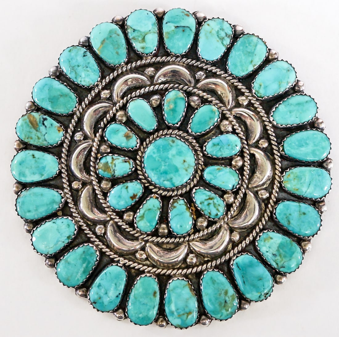 3IN Sterling Turquoise Brooch Signed 'JW': Juliana Williams Native American Turquoise and sterling cluster brooch / pendant signed 'JW' measures 3 in. diameter. Weighs 62 grams. Lot measures 3 in. H x 3 in. W x 1.5 in. D for shipping purposes