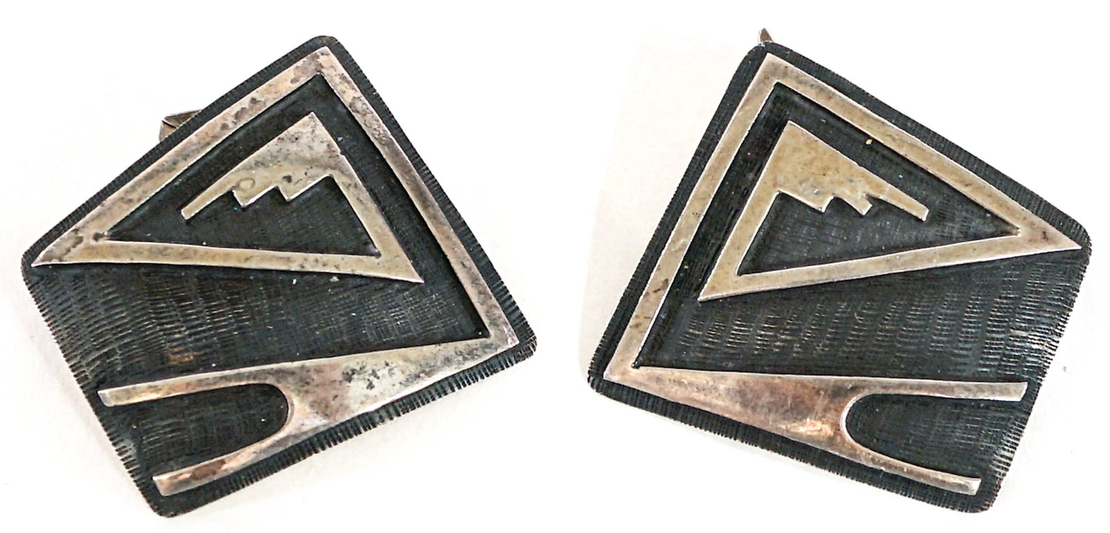 Picto Mark Pair Southwest Cufflinks: Picto Mark pair cufflinks. Each measures 1.25 x 1.25 in. Note one of the clasps / hinge is loose. Lot measures 2 in. H x 2 in. W x 1.5 in. D for shipping purposes only. The absence of a condition repo