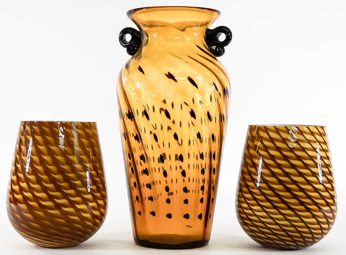 Art Glass(2) Amber Lampshades (1) Amber Vase: Lampshades measure 6 in. long x 5 in. diameter. Rims measure 1.5 in. and 3.75 in. Vase measures 11.5 in. tall x 6 x 5.5 in. No evident cracks, chips or repairs. Lot measures 11.5 in. H x 6 in. W x 16