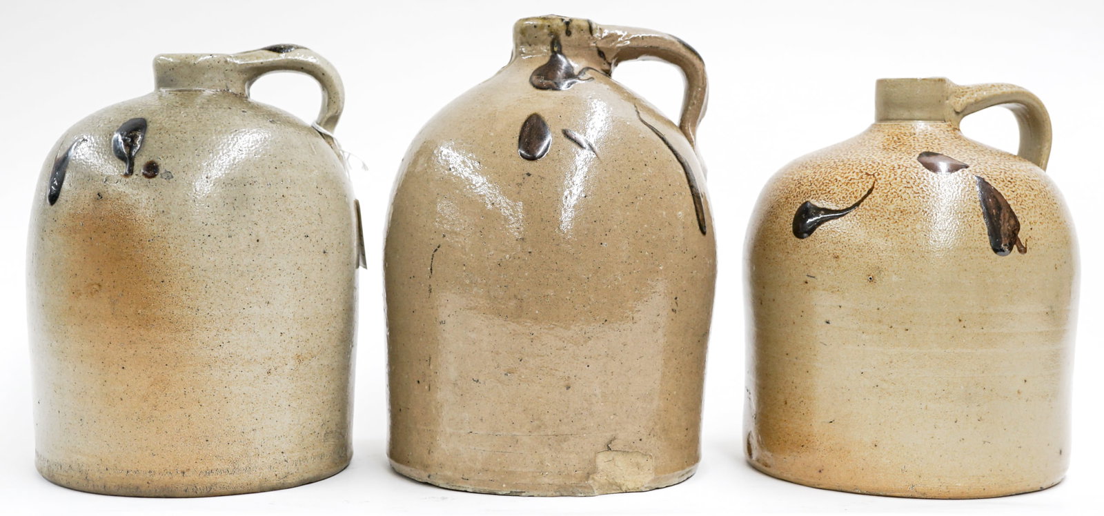 (3) Salt Glaze Stoneware Jugs: They measure 9.75-10.75 inches tall. They measure 16 x 11 x 14 inches for shipping purposes. The largest has a chip. The absence of a condition report does not imply that the lot is in perfect