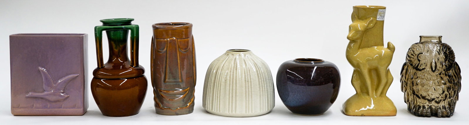 A Group of Art Pottery: A group of mostly art pottery with one glass vase. They measure 4.5-8.5 inches tall. Combined they measure 12 x 16 x 9 inches. Our in-house shipping department will gladly pack and ship any item that 