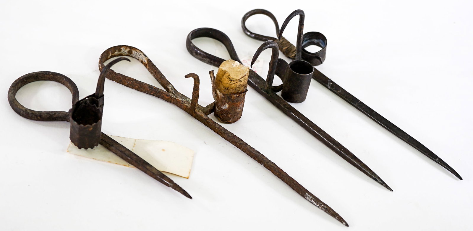 Miner's Wrought Iron Stick Lamp: Four (4) Miner's wrought iron stick lamps. Measure 7 to 10 in. long x 2 to 3.75 in. Lot measures 10 in. H x 3.75 in. W x 8 in. D for shipping purposes only. The absence of a condition report does not