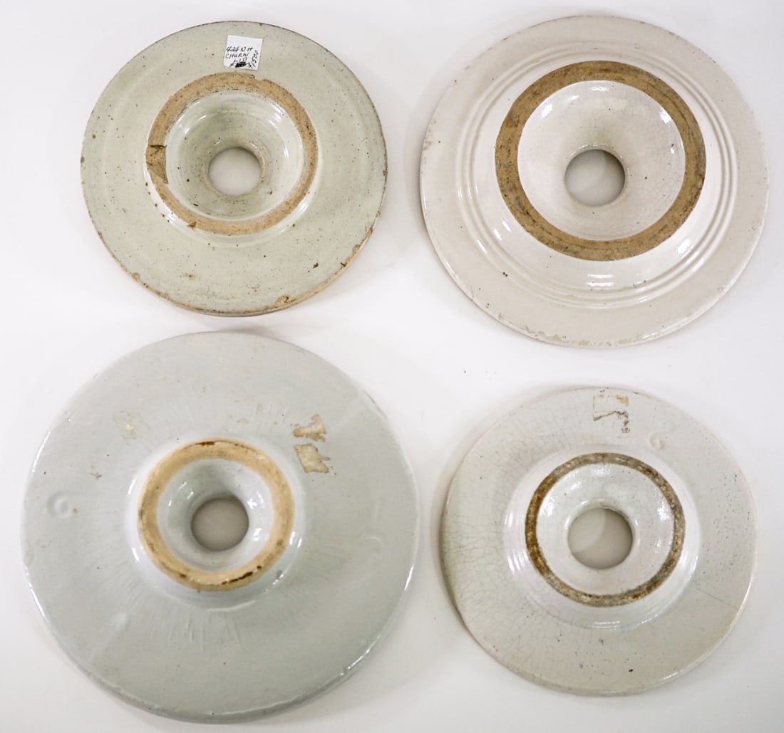 Stoneware Churn (4) Lids [Mixed Condition]: Stoneware Churn Lids (4) mixed condition. Measure 6.75 to 8.5 in. diameter. Lot measures 5 in. H x 10 in. W x 10 in. D for shipping purposes only. The absence of a condition report does not imply