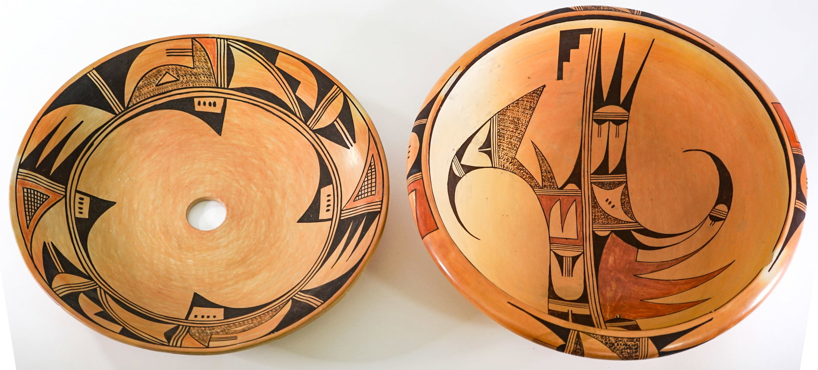 Polychrome (2) Pottery Pieces [M. Daniels]: Two (2) pottery items include M. Daniels signed 14.5 in. bowl (note chipped); and unsigned 14 in. plate with hole in center. Lot measures 4.5 in. H x 14.5 in. W x 14.5 in. D for shipping purposes