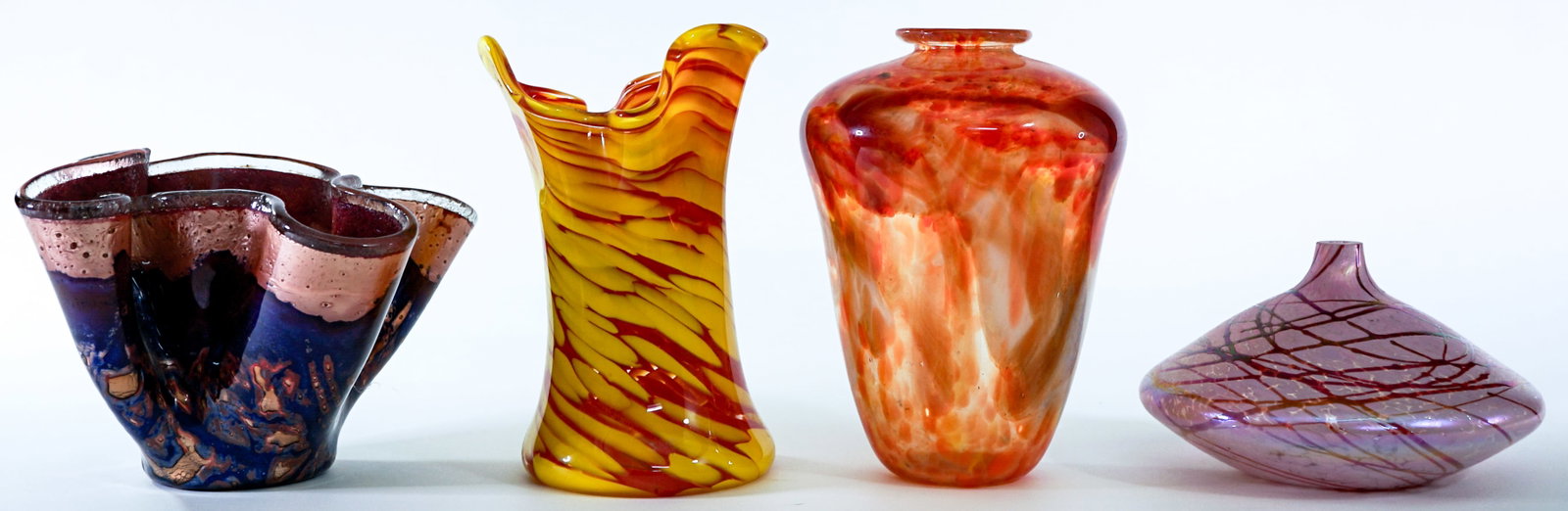Art Glass (4) Artist Signed: Four (4) art glass pieces measure 4.5 in. to 8 in. tall. No evident cracks, chips or repairs. Lot measures 8 n. H x 14 n. W x 14 in. D for shipping purposes only. The absence of a condition report