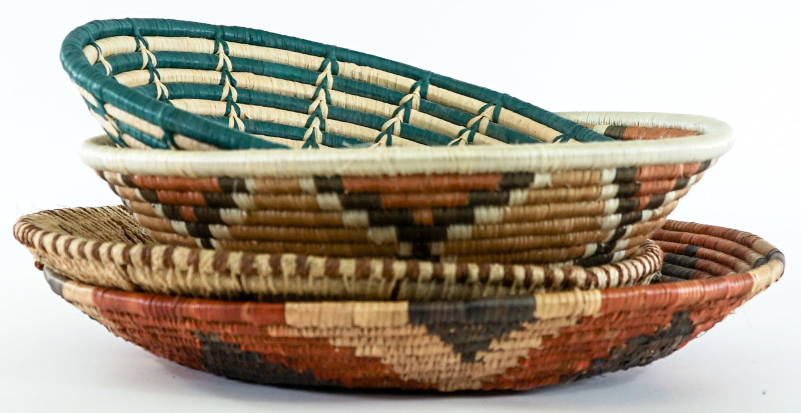 Woven (4) Baskets: Woven (4) basketry items. Lot measures 5 in. H x 13.5 in. W x 13.5 in. D for shipping purposes only. The absence of a condition report does not imply that the lot is in perfect condition or