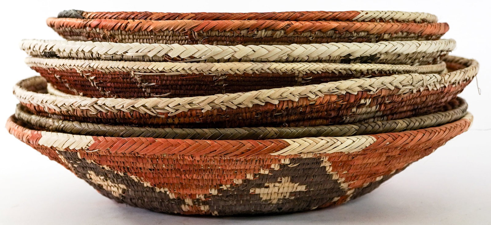 Group of Woven Baskets [8]: Group of Woven Baskets [8]. Lot measures 6.5 in. H x 16 in. W x 16 in. D for shipping purposes only. The absence of a condition report does not imply that the lot is in perfect condition or
