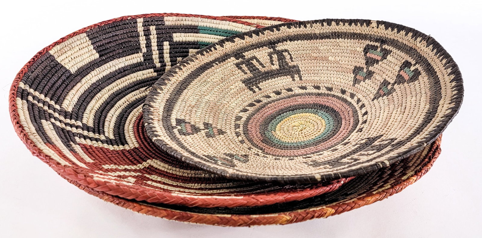 Handwoven Baskets [3]: Lot measures 4 in. H x 15.5 in. W x 15.5 in. D for shipping purposes only. The absence of a condition report does not imply that the lot is in perfect condition or completely free from wear and tear,
