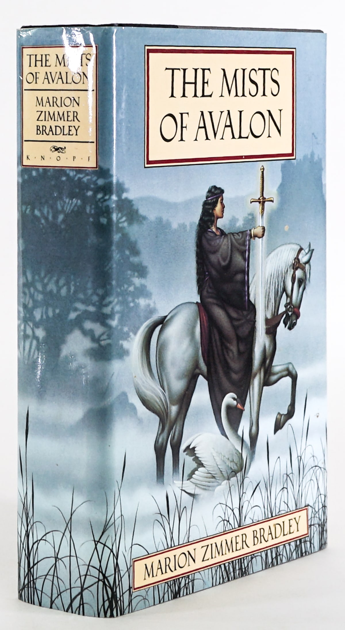 The Mists of Avalon by Bradley SIGNED 1982 1ST: The Mists of Avalon by Marion Zimmer Bradley signed with inscription. Alfred A. Knopf 1982 1st with unclipped dust jacket. 876 pp. Two-tone covers. Lot measures 9.5 in. H x 6.5 in. W x 2 in. D for