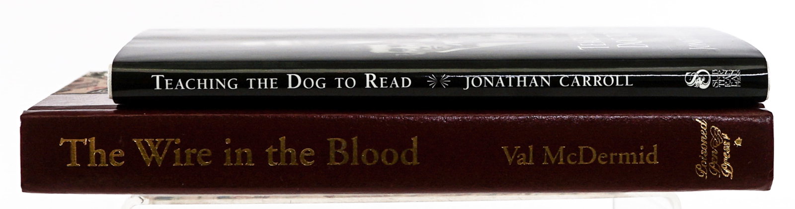Author (2) SIGNED LTD Editions: 1) Teaching the Dog to Read by Jonathan Carroll signed and numbered 50/1000 copies. 2) The Wire in Blood by Val McDermid and Michael Connelly numbered 200 of 300 copies, both signed. Lot measures 9.5 