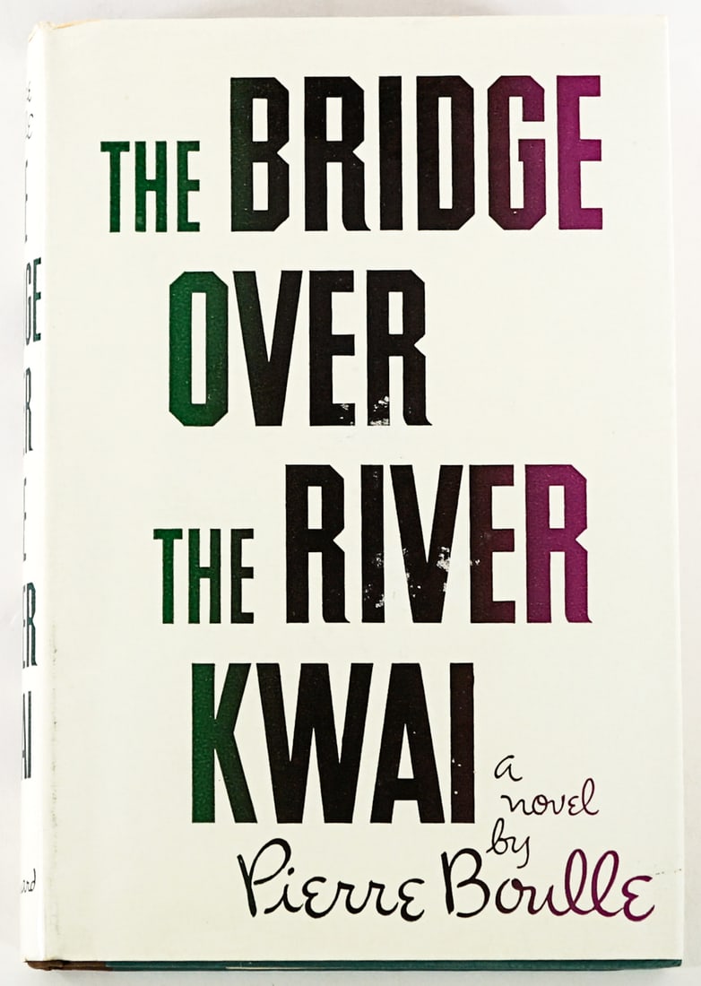 Bridge Over The River Kwai by Boulle 1954 1st: The Bridge Over the River Kwai by Pierre Boulle. Vanguard Press 1954 1st with unclipped dust jacket. 224 pp. Two-tone covers. Owner name inside front cover. Lot measures 8.5 in. H x 6.in. W x 1 in. D